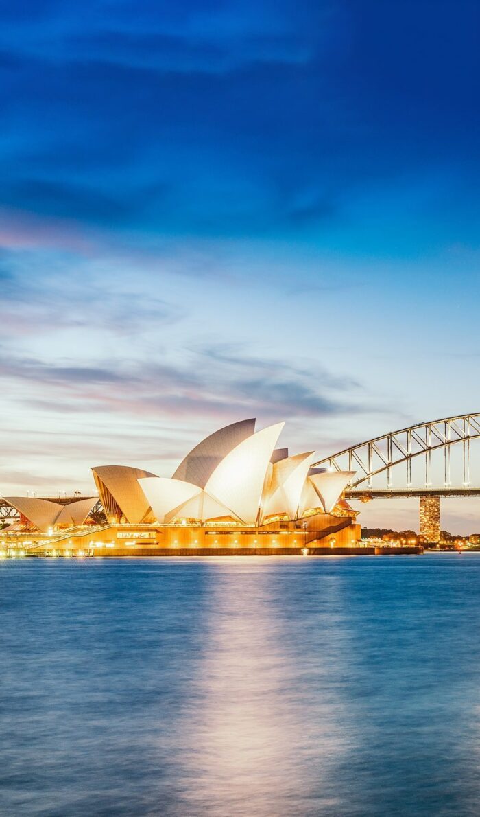 View of illuminated Sydney Opera House at dawn