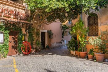Greened alley and entrance to a restaurant in Trastevere, Rome