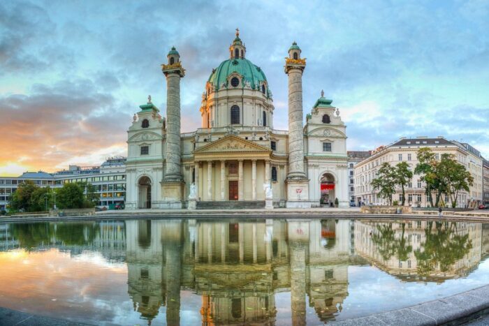 Karlskirche - Church in Vienna, being reflected in the water of a fountain