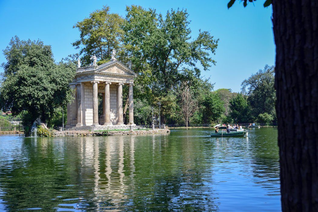 Lake with island and temple at the Villa Borghese Park in Rome.