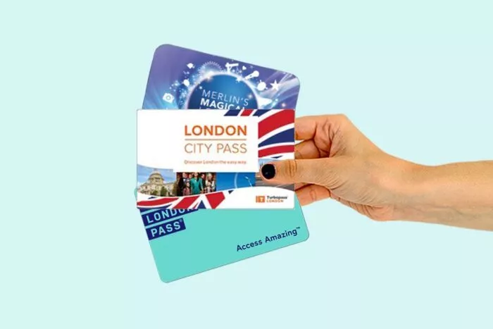 Hand holding a selection of London city passes.